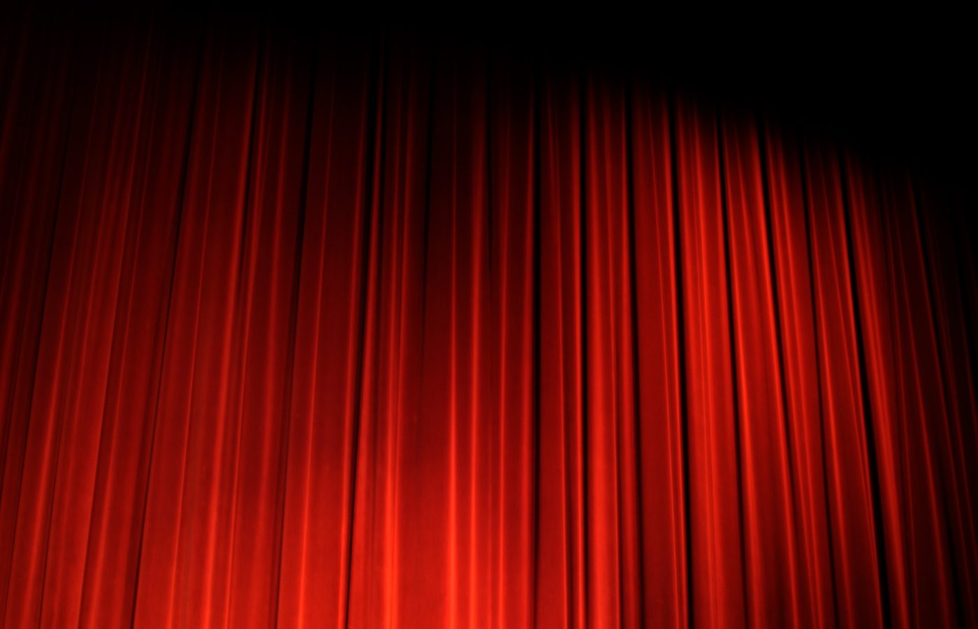 Deep red draped curtain and its highlights under strong directional light
